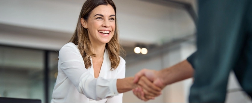 Happy client shaking hands with mortgage broker
