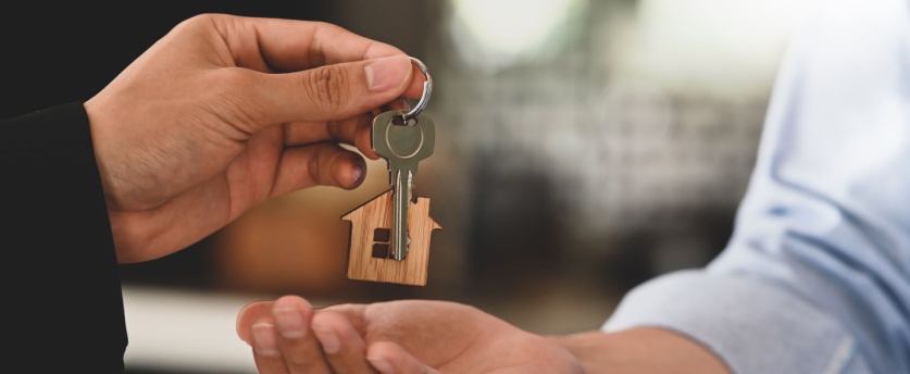 Landlord handing over the keys to a rental house