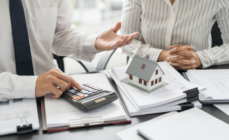 investors at table with calculator and paperwork