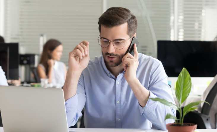 sales person talking on the phone with client.